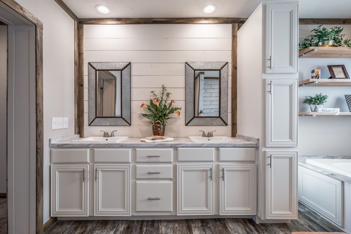 A bathroom with two sinks and a tub.