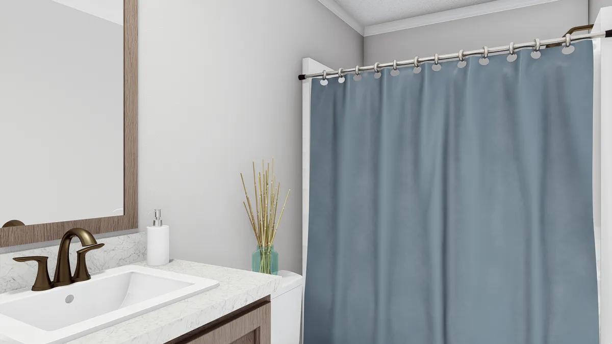 f740127b-f7d5-48c2-a76b-ec73ed635856 A bathroom with a blue shower curtain.