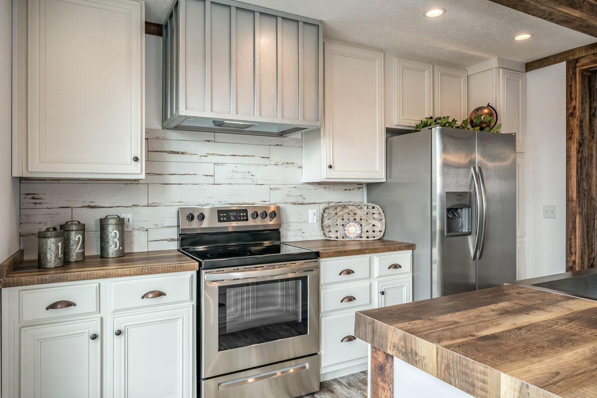 A kitchen with wood cabinets and stainless steel appliances.