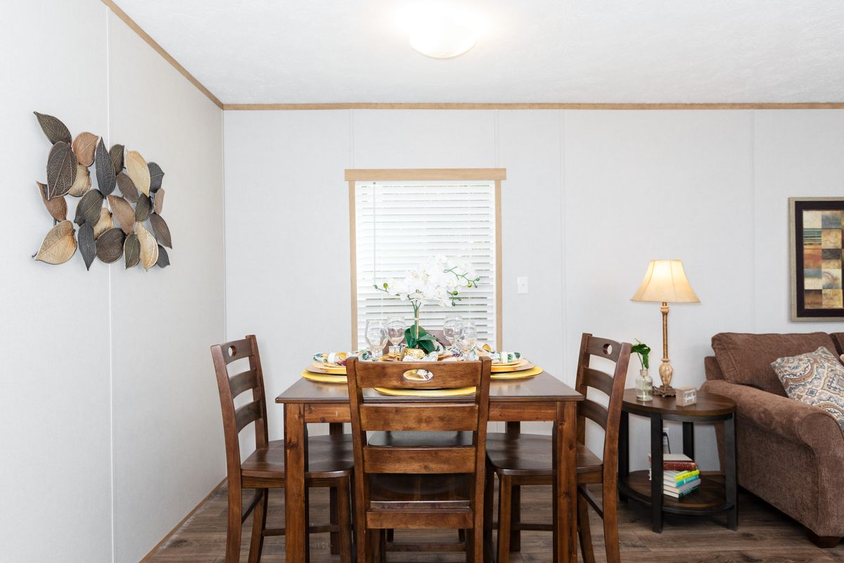 A living room and dining room in a mobile home.