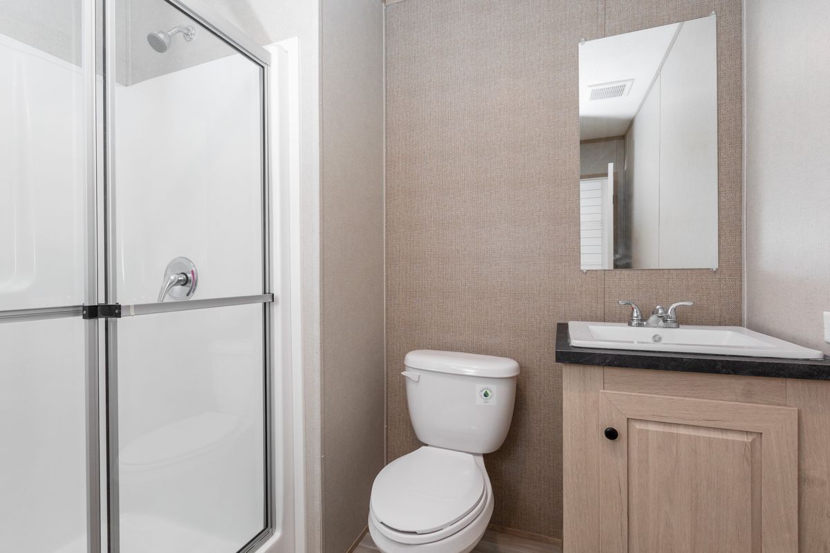 fea195d1-353e-4d24-a094-70aa9065cee5 A small bathroom with a toilet and shower.
