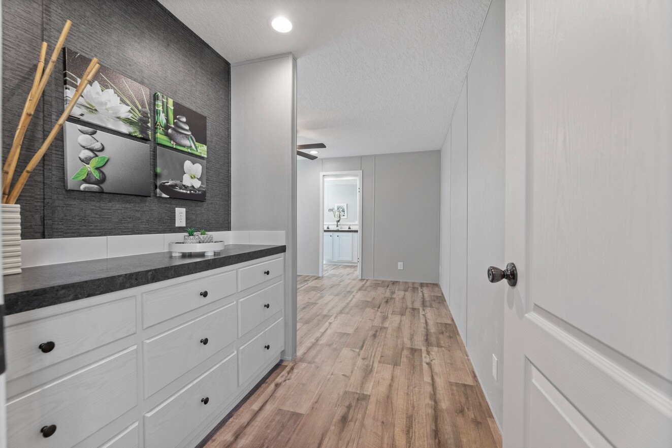 the_clarke_52769723341_o_1679953686355_1323_12 A white and gray hallway with a picture on the wall.