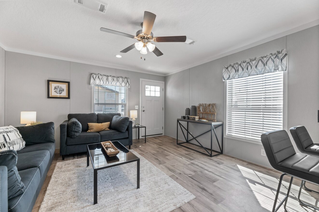 the_clarke_52769981414_o_1679953614167_1323_12 A living room with hardwood floors and a ceiling fan.