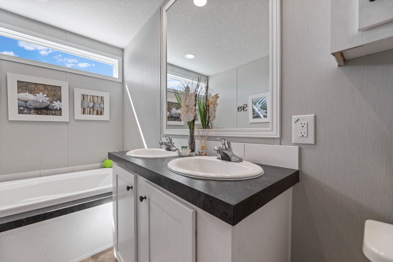 the_clarke_52770138150_o_1679953516808_1323_12 A bathroom with a sink, toilet and tub.