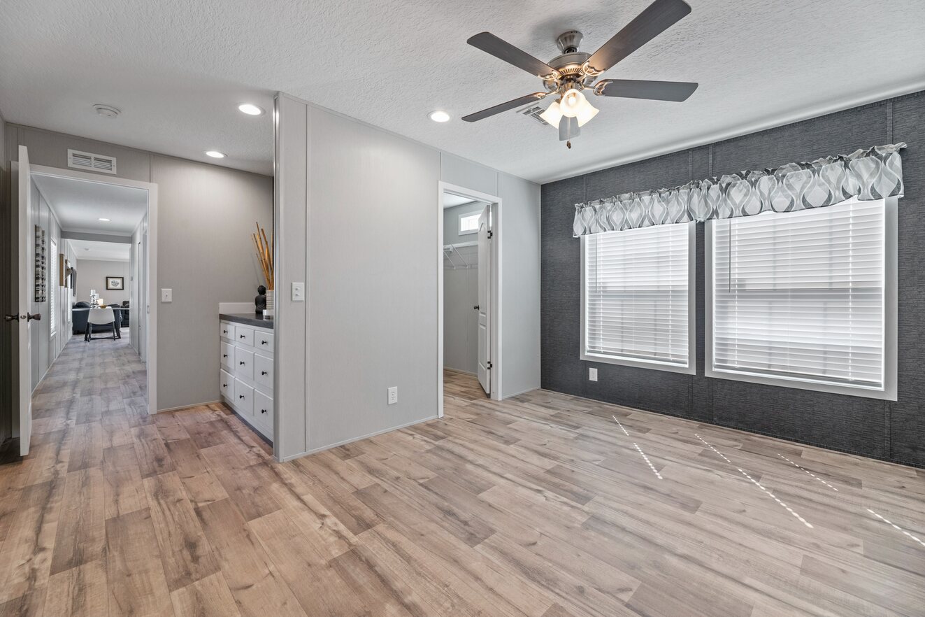 the_clarke_52770213803_o_1679953483337_1323_12 An empty room with wood floors and a ceiling fan.