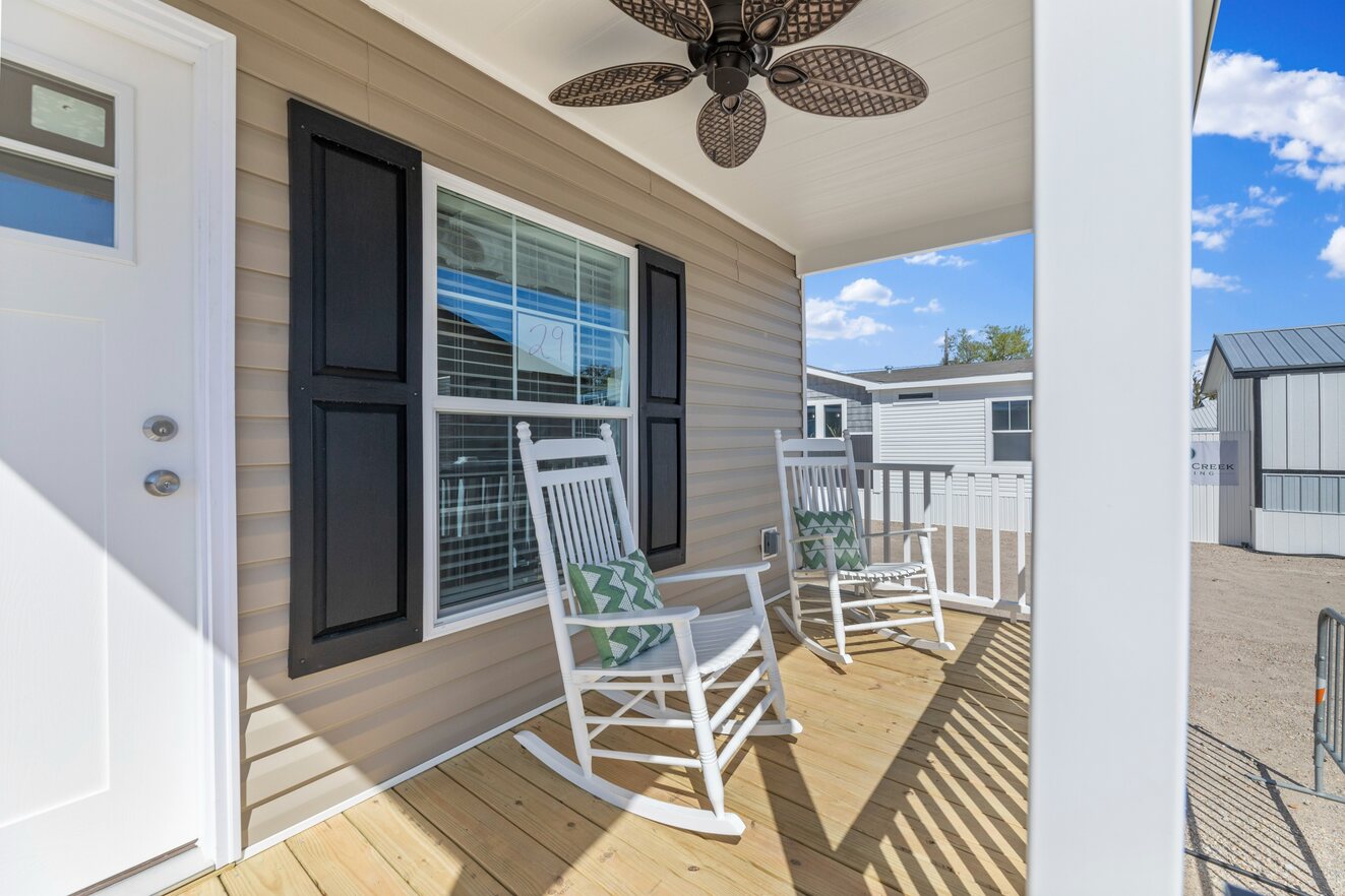 the_clarke_52770215413_o_1679953451674_1323_12 Rocking chairs on the porch of a mobile home.
