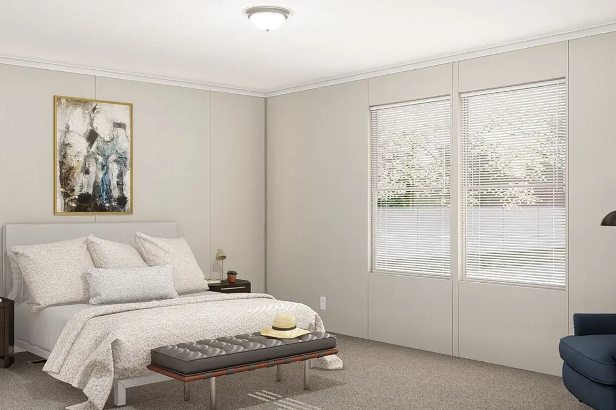 A bedroom with a bed and a bench.