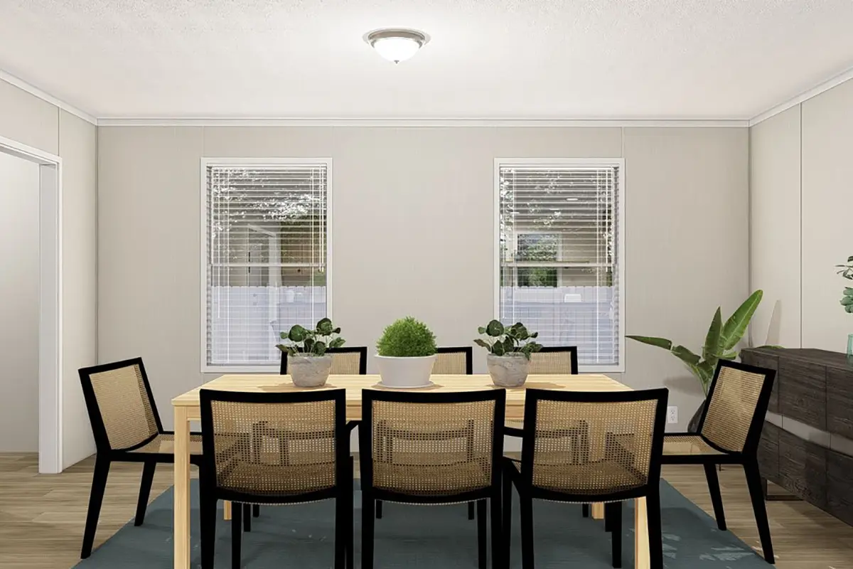A dining room with a table and chairs.