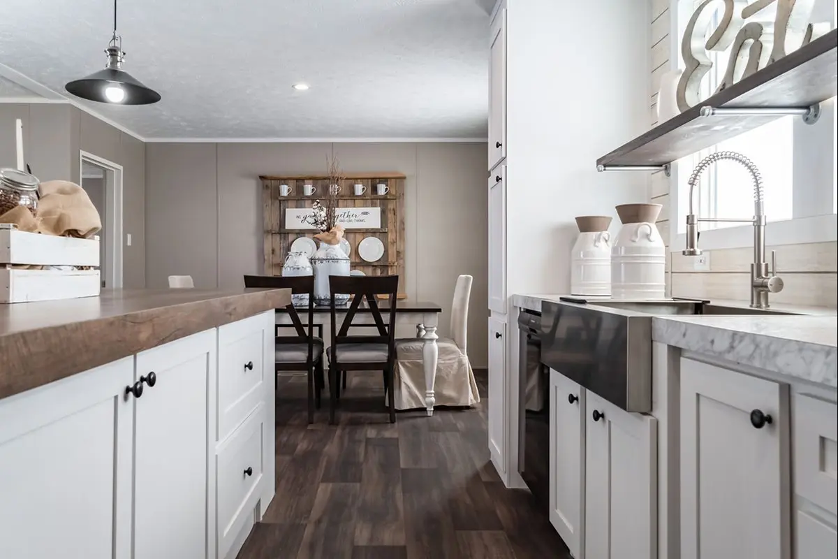 A kitchen with a table and chairs.