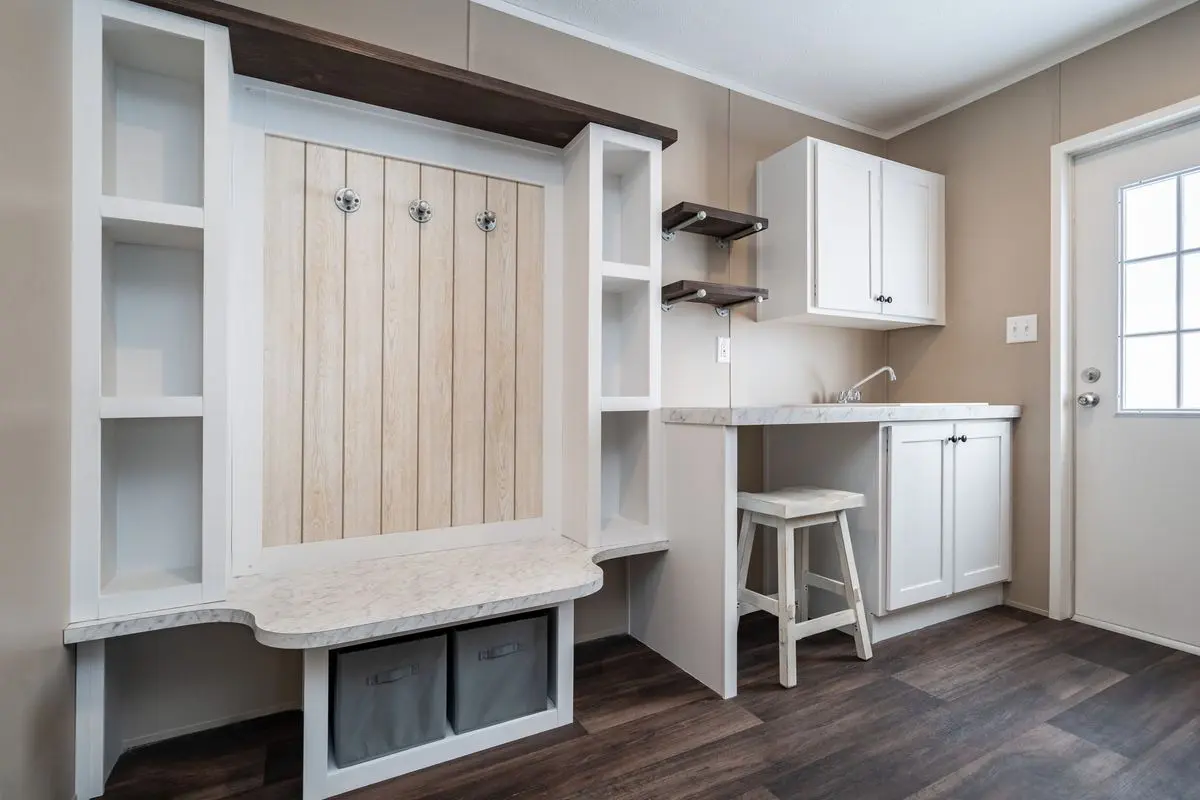 A room with white cabinets and white countertops.