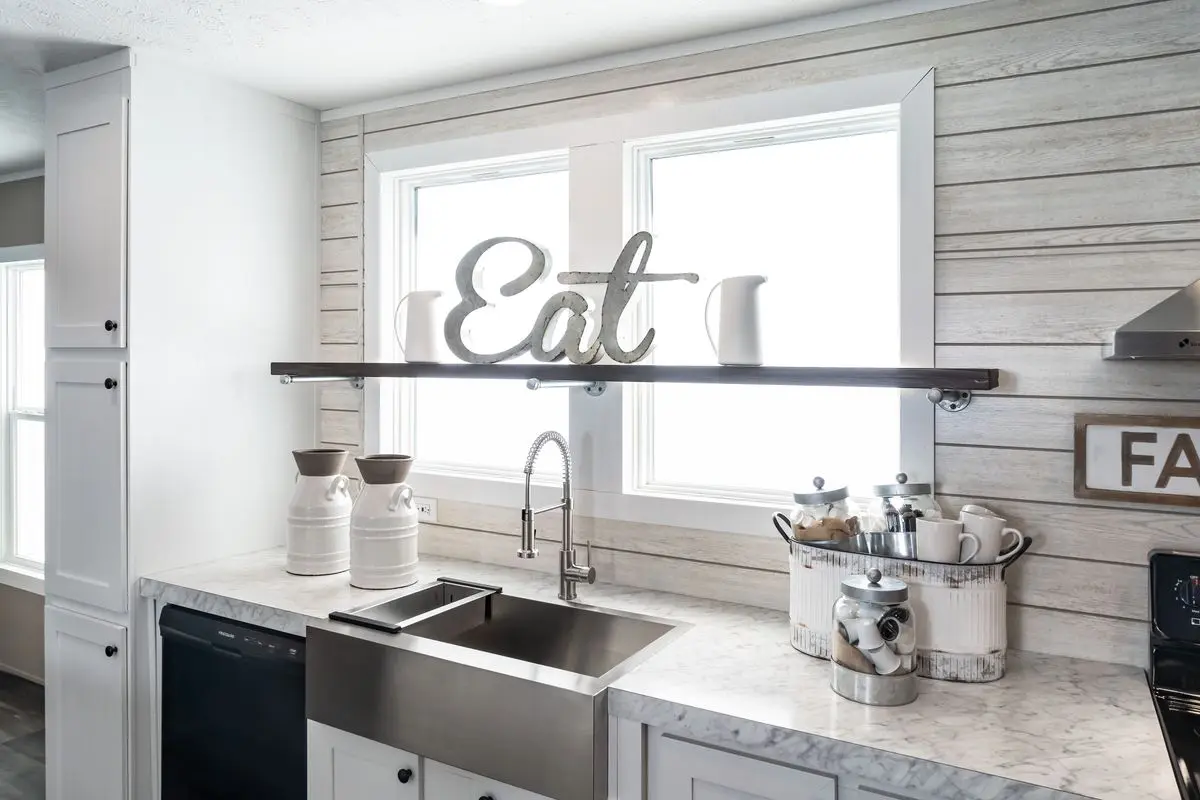 A kitchen with a sink and a sign.