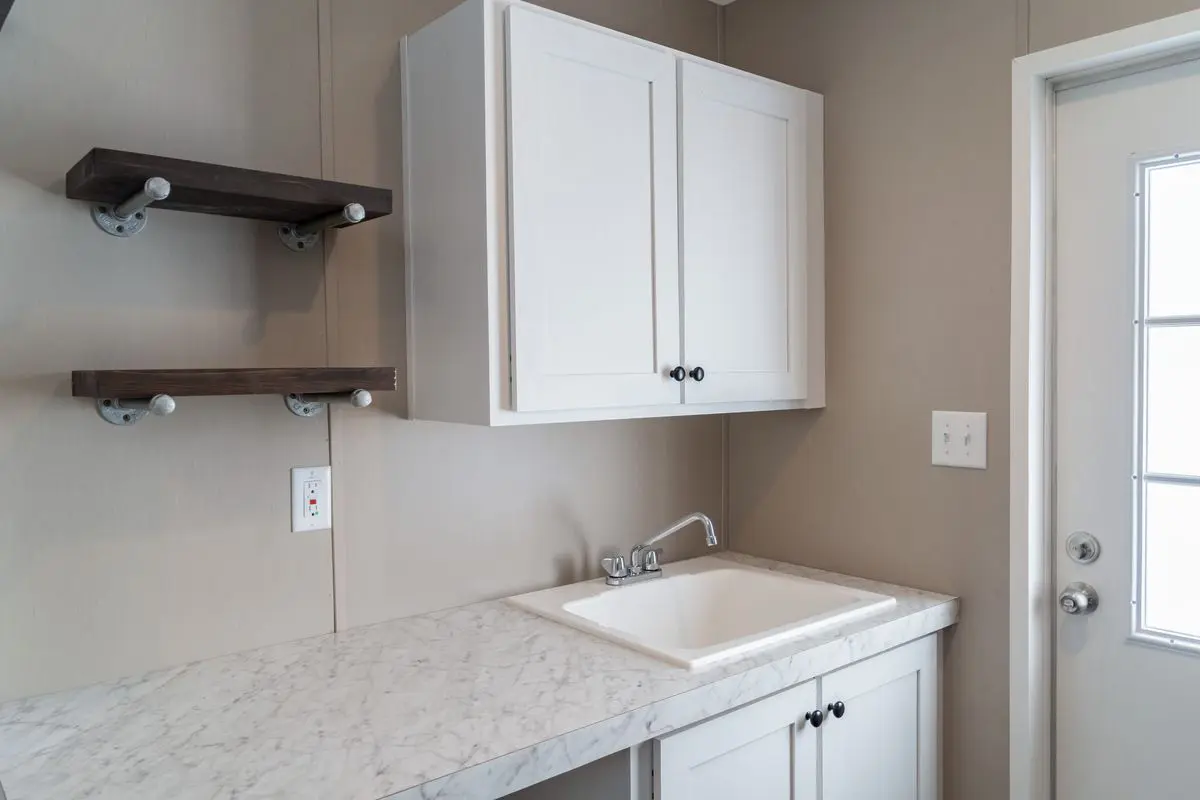 A white sink and cabinets in a kitchen.