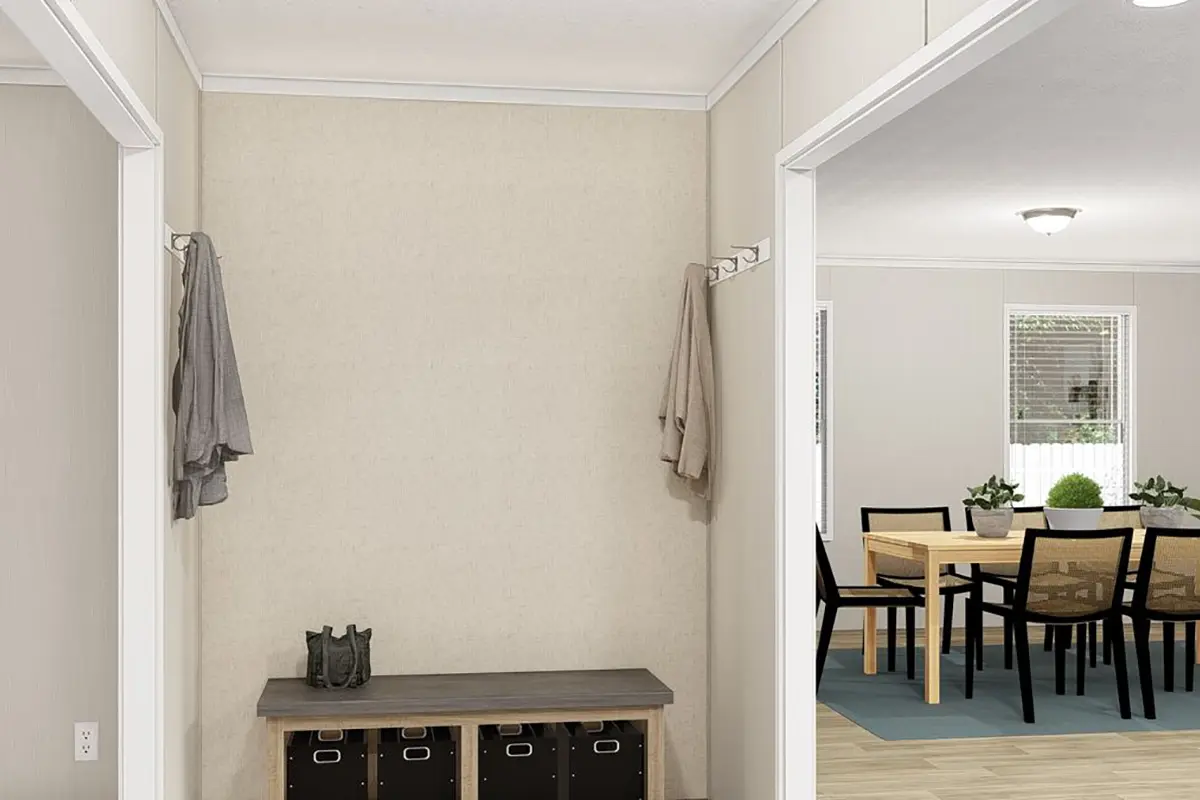 A hallway with a table and chairs.