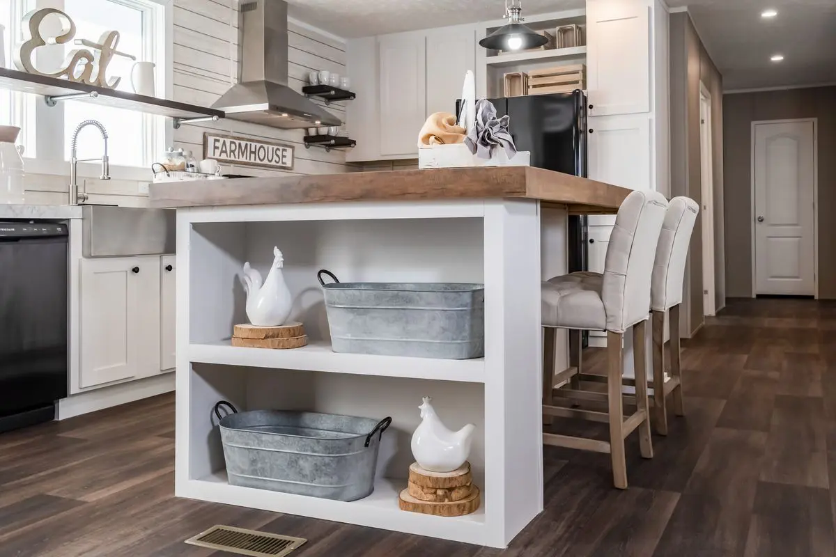 A kitchen with a table and chairs.