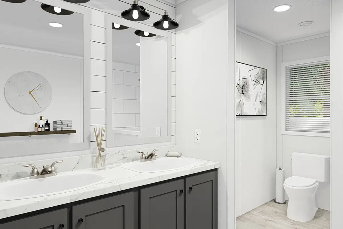A bathroom with two sinks and a mirror.