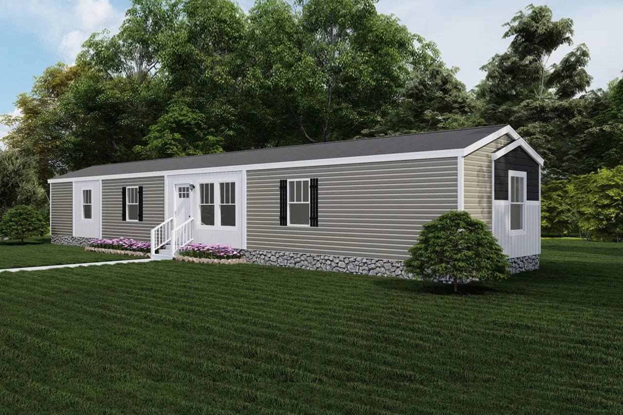 Baby-Boujee-0534aa0a-848a-42b6-86cf-f400457d9c8f A single-story, beige manufactured home with white trim sits on a well-maintained lawn, surrounded by trees. The home features a small porch with steps leading to the front door and a decorative foundation.
