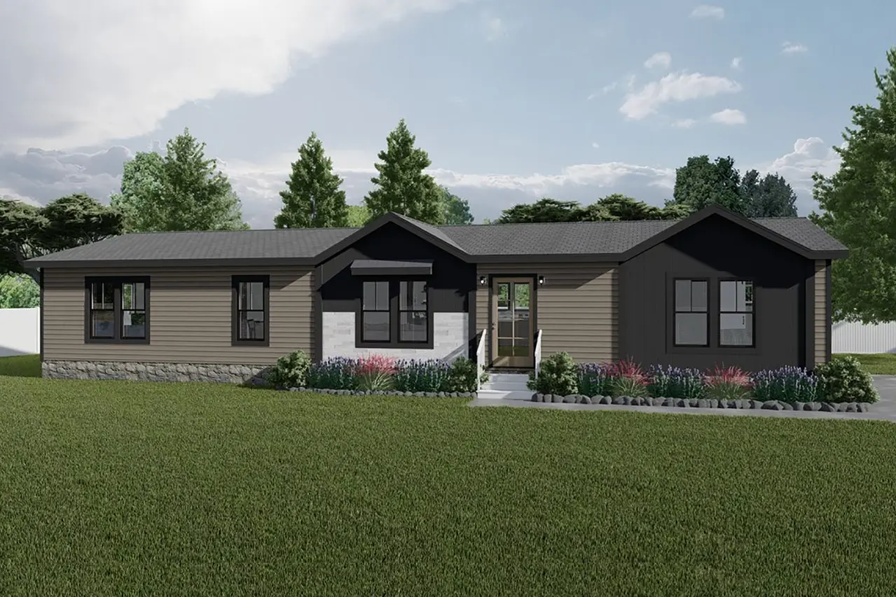 A modern, single-story home with gray siding, black trim, and a landscaped front yard with bushes and flowering plants. The house has a central entryway and is set against a backdrop of green trees.