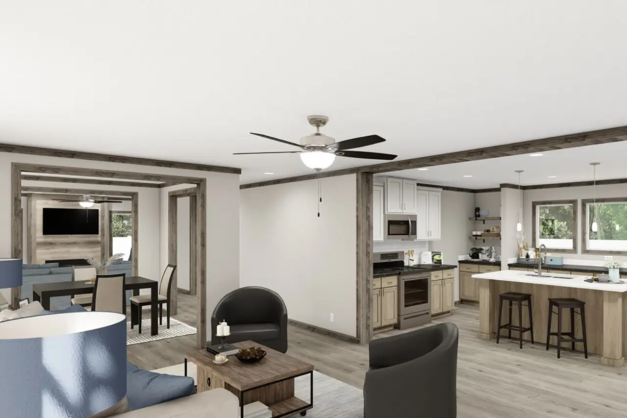 A modern open-concept living area features a kitchen with white cabinets, wood accents, a dining area, and a cozy seating space with neutral-toned furniture and ceiling fans.