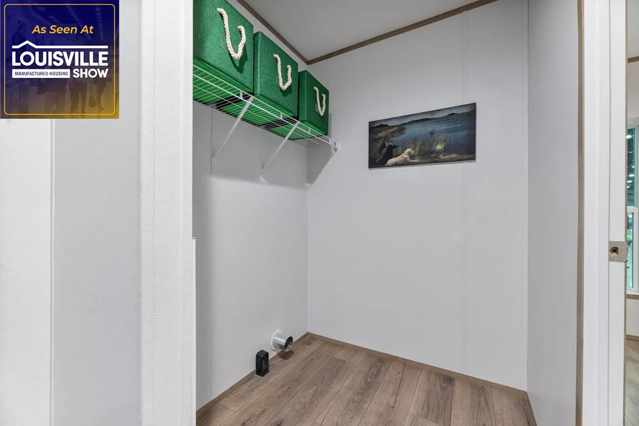 A small, empty closet with three green storage bins on a shelf, a framed picture on the wall, and a wooden floor. "As Seen At Louisville Show" is displayed in the top left corner.