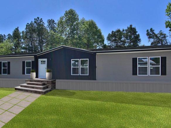 A modern manufactured home with gray and dark blue siding, white trim, front steps, and two potted plants, set on a grassy lawn with trees in the background.