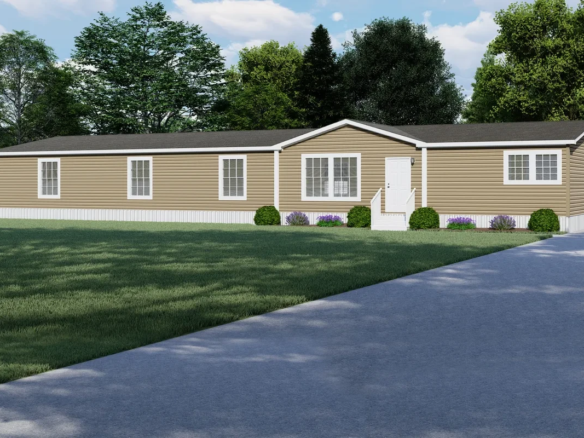 Single-story beige manufactured home with white trim, a small front porch, shrubs, and a paved driveway, surrounded by green lawn and trees.