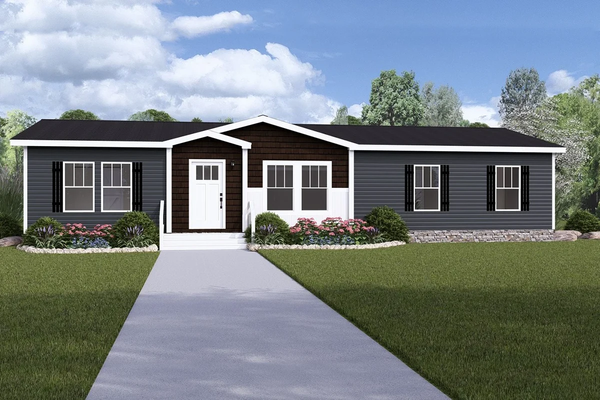 A modern single-story manufactured home with dark siding, white trim, a central entrance, front steps, and landscaped shrubs along the walkway.