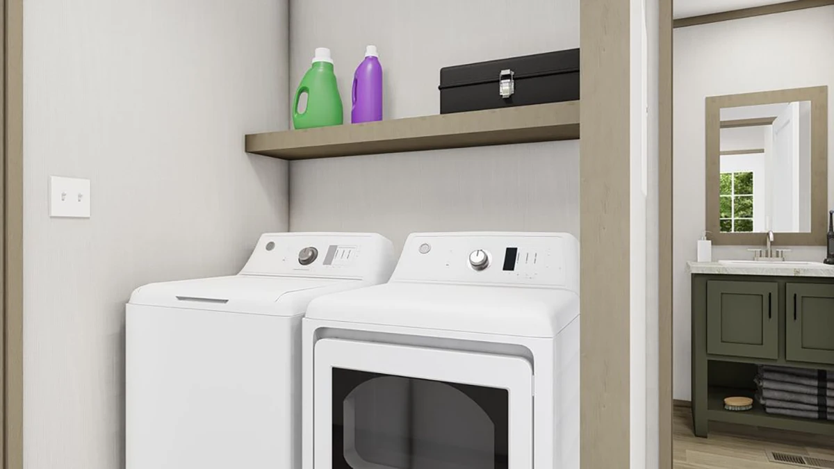 032218d2-3303-431c-ac3b-c6d0704cc4d2 A laundry area with a white washing machine and dryer, a wooden shelf above holding detergent bottles and a black box; a bathroom with a green vanity is visible in the background.