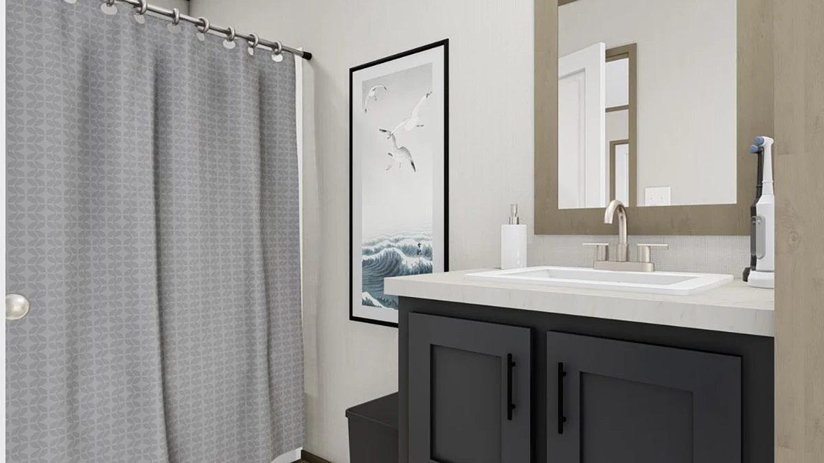 Modern bathroom with a gray shower curtain, black vanity with white countertop, wall-mounted mirror, and framed ocean-themed artwork.