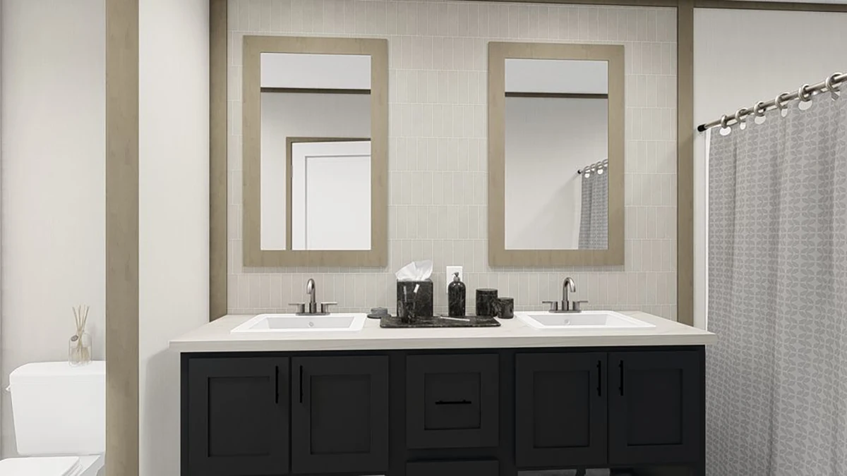 A modern bathroom with dual sinks, two mirrors, black vanity cabinets, a tissue box, soap dispenser, and a shower with a patterned curtain. A toilet is visible on the left.