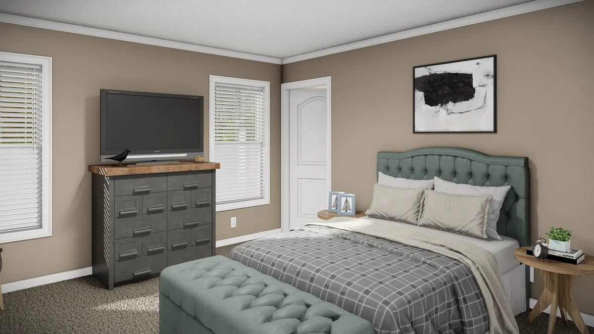 0b3c4b23-2cfa-43c8-8f5f-beab54e3bfc7 A neatly made bed with plaid bedding, a tufted headboard, a chest of drawers with a TV on top, and two windows in a beige-walled bedroom.