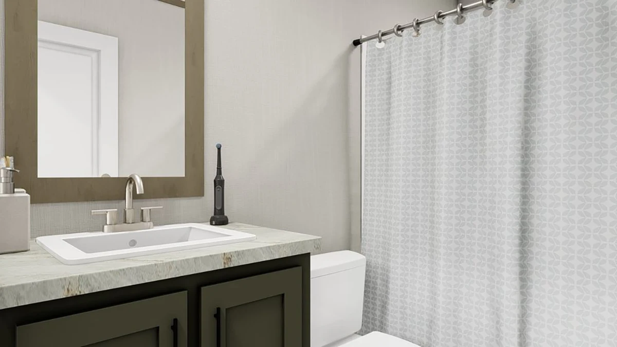 A modern bathroom with a sink, mirror, electric toothbrush, toilet, and a shower with a patterned gray curtain.