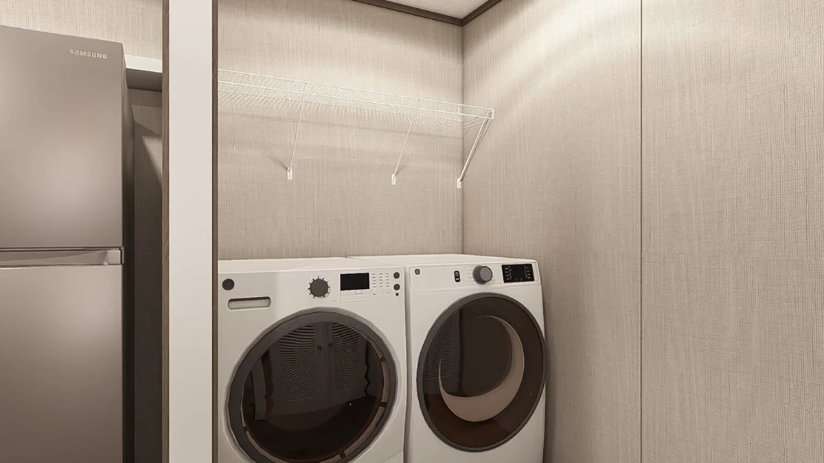 A laundry area with a front-loading washer and dryer side by side below an empty wire shelf, next to a stainless steel refrigerator.