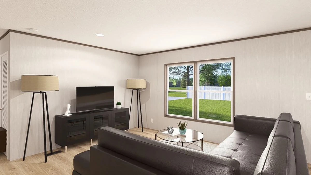 Modern living room with two sofas, a TV on a stand, two floor lamps, a glass coffee table, and a large window showing a green yard with trees and a white fence.