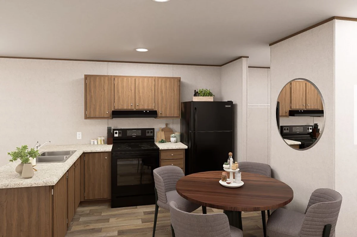0f6a8798-4f82-49c9-bde2-c8f6656df16a Modern kitchen with wood cabinets, black appliances, round dining table with four chairs, a wall mirror, and simple decor on countertops.