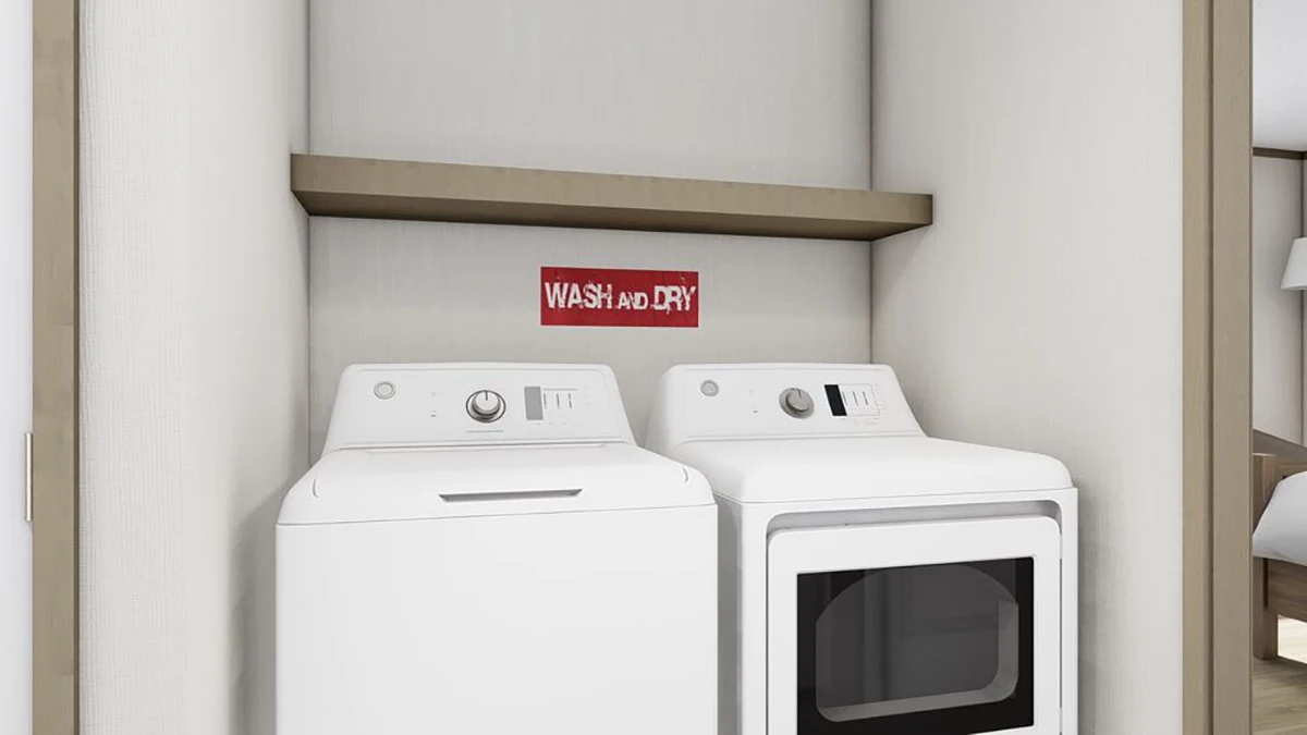 A washer and dryer are placed side by side in an alcove with a shelf above and a red sign that reads "WASH and DRY" on the wall.