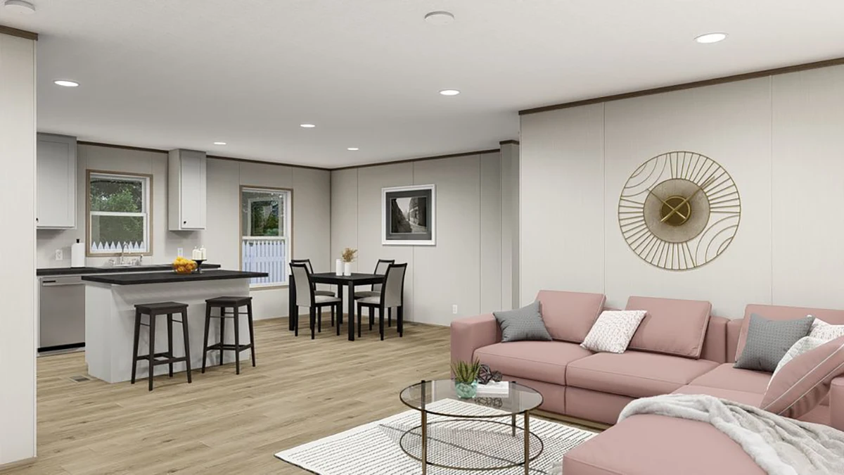 132ed430-0fee-44f9-a0d4-f214eb9280a6 Open-plan living area with pink sectional sofa, round glass coffee table, kitchen with island and stools, dining table, and wall art, featuring neutral tones and wood flooring.
