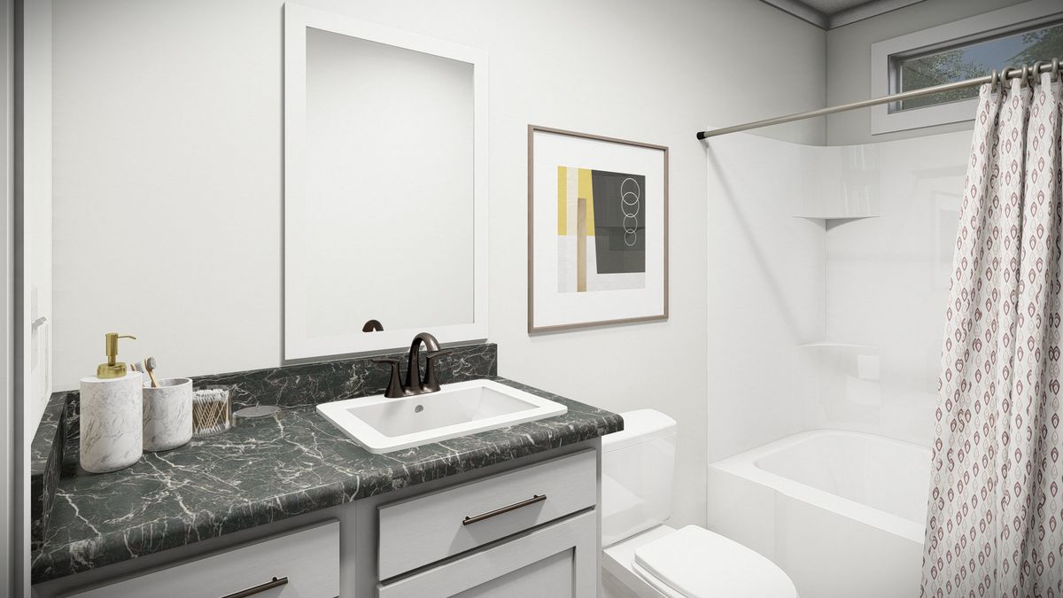 15453a80-b9c5-47b0-b2d2-d299d70c49a6 Modern bathroom with a dark marble countertop, white sink, framed mirror, wall art, toilet, and a bathtub with a patterned shower curtain.