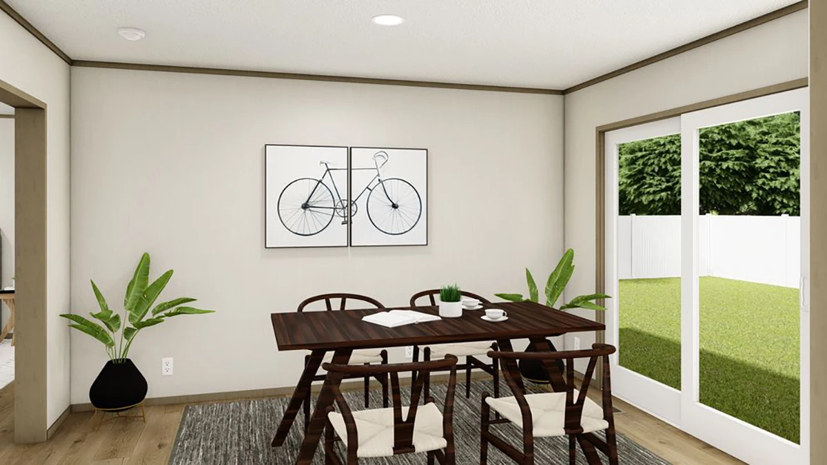A dining room with a dark wooden table, six chairs, two potted plants, wall art of a bicycle, a rug, and glass doors opening to a grassy yard.