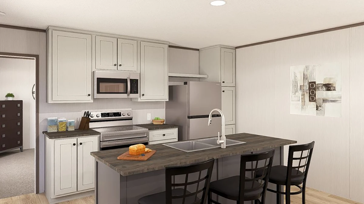 Modern kitchen with light-colored cabinets, stainless steel appliances, a central island with sink, three chairs, and a loaf of bread on a cutting board.