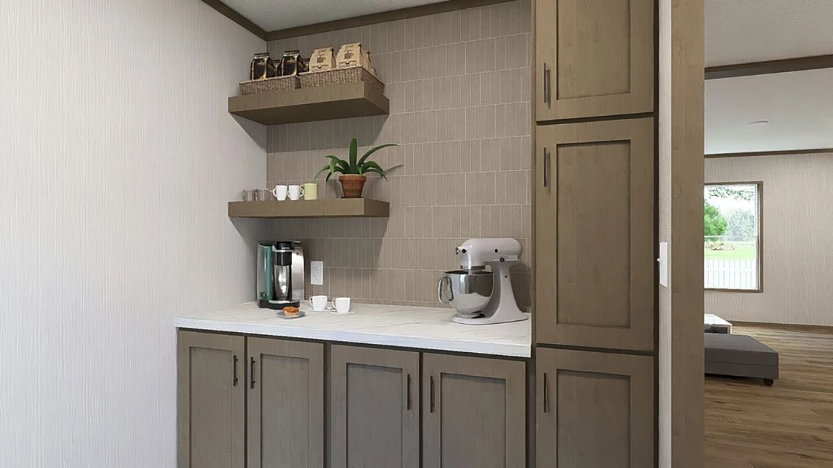 A kitchen corner with wooden cabinets, a mixer, a coffee maker, cups, a small plant, and shelves holding jars and containers against a tiled backsplash.