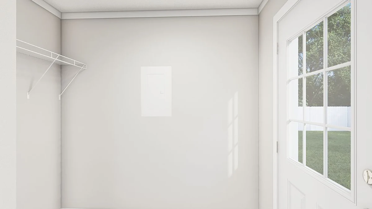 A small room with light-colored walls, a wire shelf on the left, an electrical panel on the wall, and a door with window panes leading outside to a fenced yard.