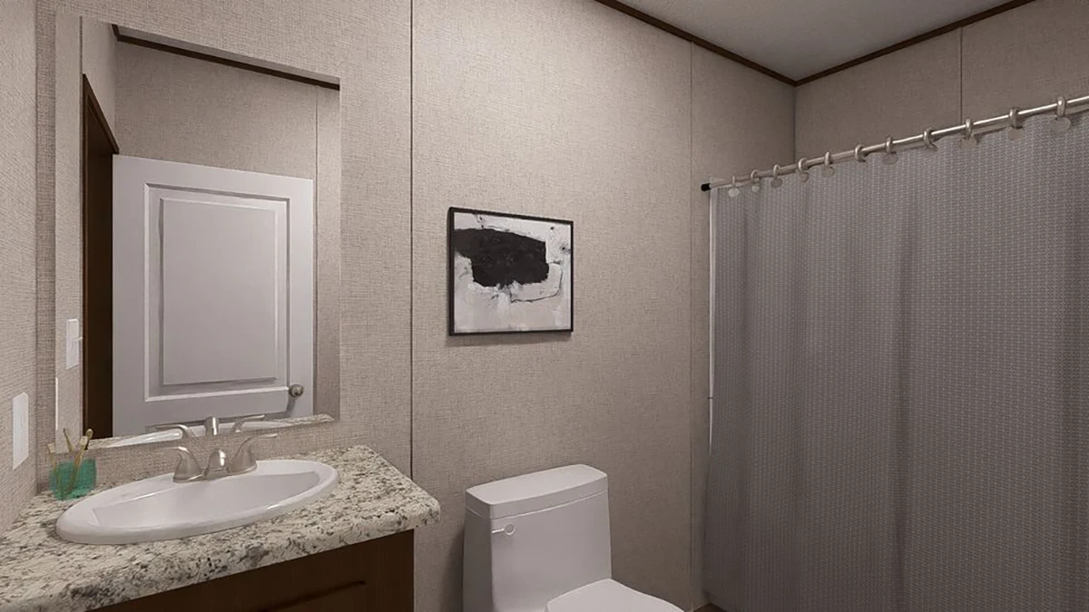 1b4a6756-4d9d-4d3e-97b8-8324ad53a14a A bathroom with a sink, granite countertop, toilet, wall art, and a shower with a gray curtain.