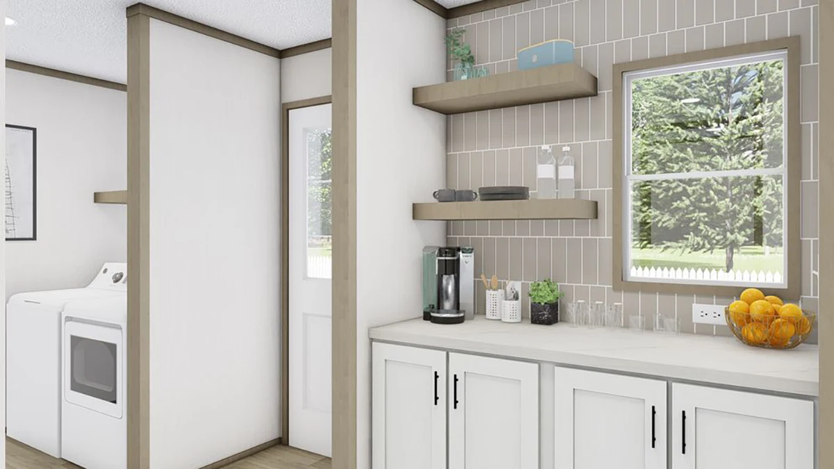 Modern laundry room with a washer and dryer, countertop with a coffee maker, glassware, and a bowl of oranges, open shelves, window, and beige tile backsplash.