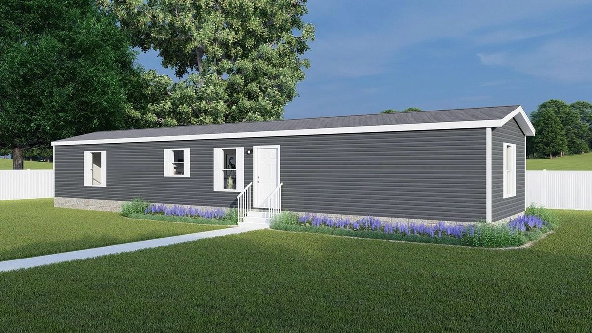 1bff7f48-906c-4afb-a1b7-23146c34884e A modern single-wide mobile home with gray siding, white trim, and a small front stoop, surrounded by grass, purple flowers, and a white fence.