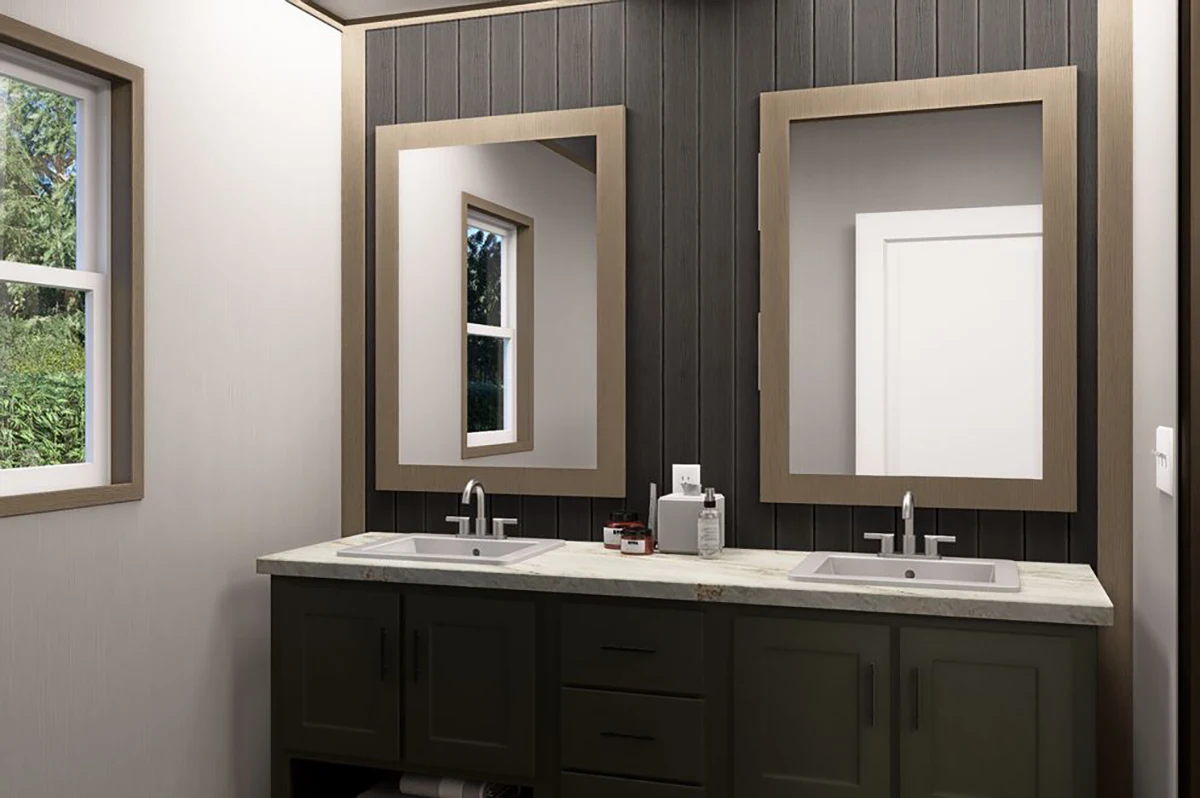 1d2b6c69-7081-4b5b-b136-e811cde2703c A bathroom with a double sink vanity, two framed mirrors, dark cabinetry, a marble countertop, and two windows providing natural light.