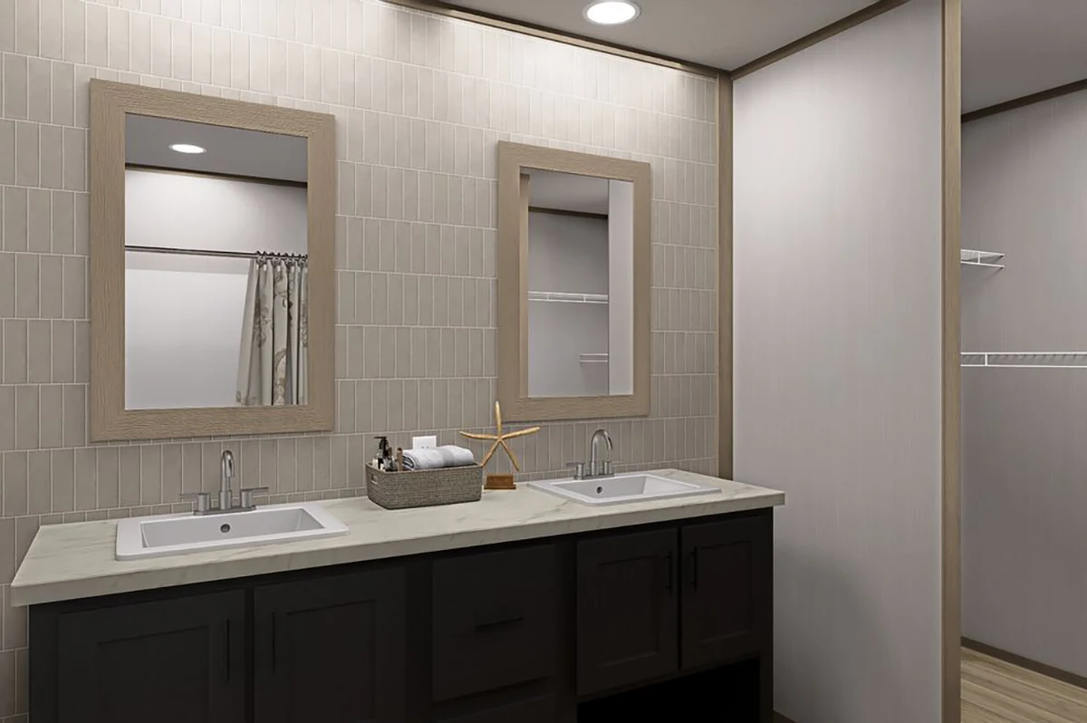 Modern bathroom with double sinks, rectangular mirrors, dark cabinets, and a basket of toiletries on the countertop. Closet space with shelves visible in the background.