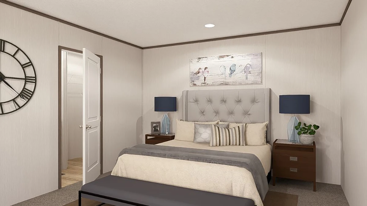 A modern bedroom with a bed, tufted headboard, two nightstands with lamps, a wall clock, bird artwork, and a bench at the foot of the bed. An open door reveals a hallway.