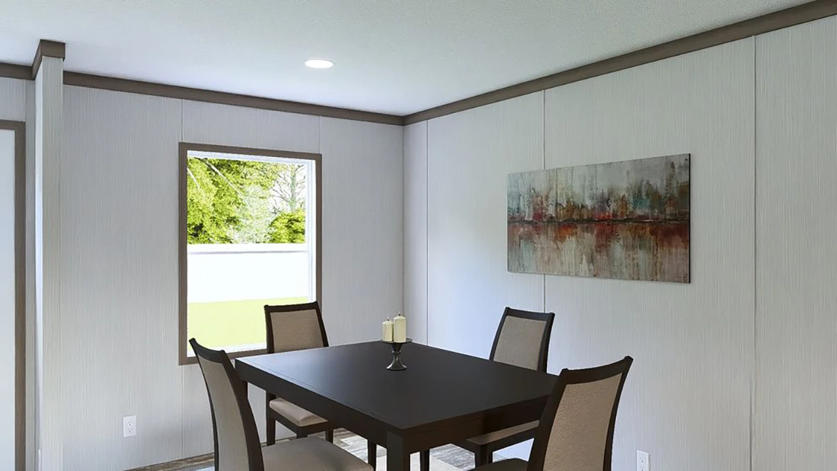 A dining area with a dark wood table, four chairs, two candles, a window showing greenery, and a landscape painting on the wall.