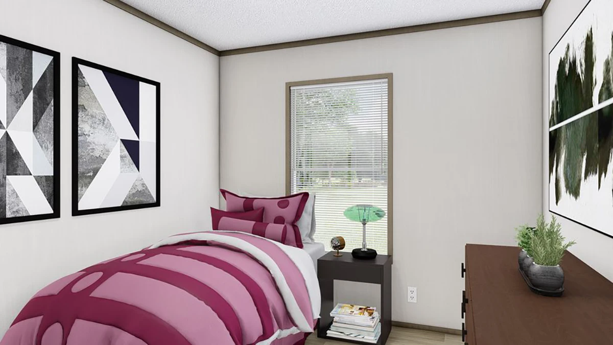 A small bedroom with a single bed featuring magenta bedding, geometric wall art, a side table with books and a lamp, a dresser, and a window with blinds.