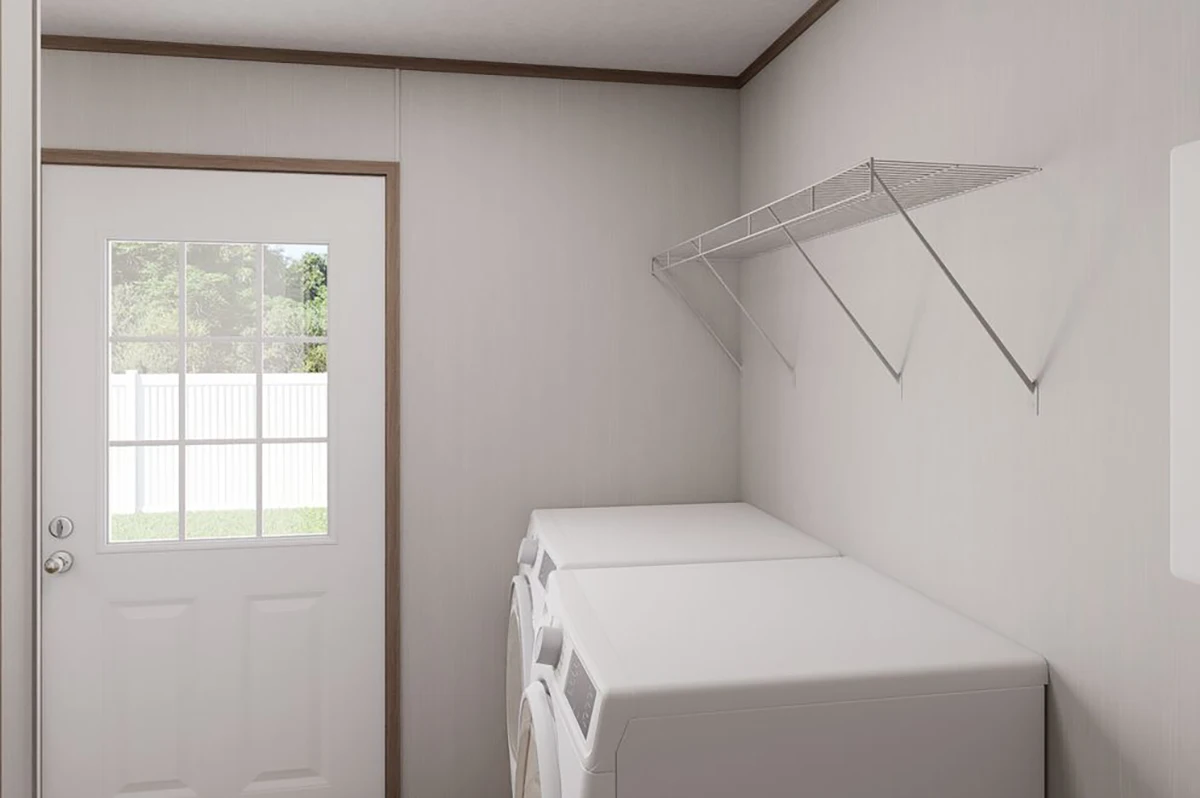 29c80f4c-18b8-466d-843c-3ea718980f58 A laundry room with a door, two white appliances side by side, and a metal wire shelf mounted on the wall above them.